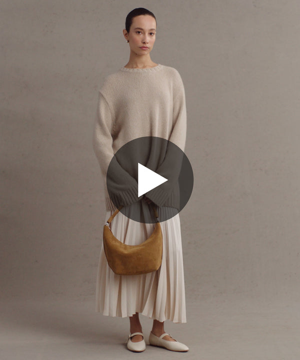 Model wearing Cashmere Amelia Crewneck in Warm Sand.