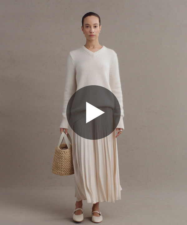Model wearing Cashmere Kate V-Neck and Pleated Skirt.