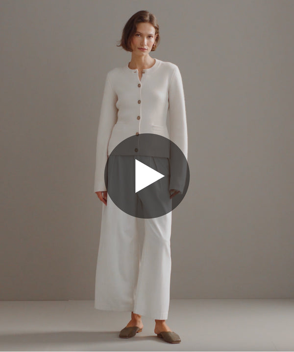 Model walking in-studio wearing Cooper Cardigan in Ivory.