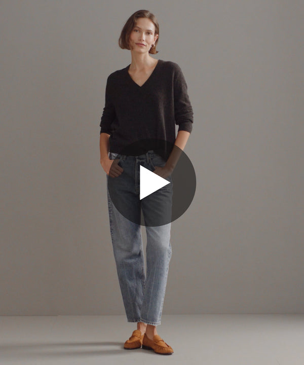 Model walking in-studio wearing Flynn Cashmere Sweater in Charcoal.